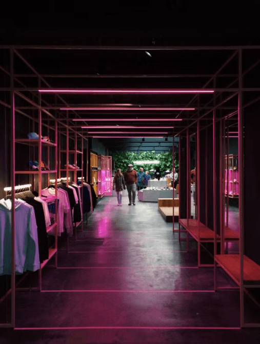 Modern retail space with pink illuminated shelving